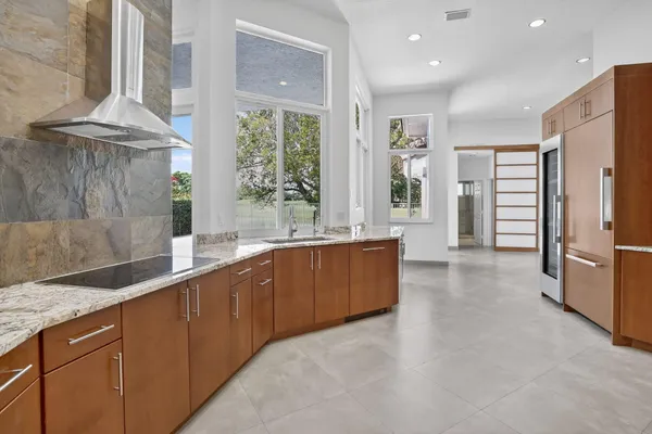 a view of an entryway with wooden floor and a kitchen