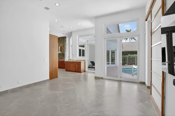 a view of a hallway with wooden floor and windows