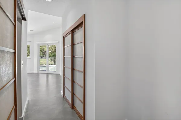 an empty room with a mirror and a window