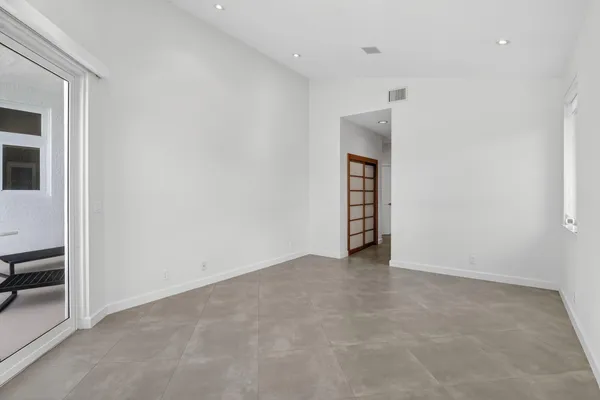 a view of a livingroom with wooden floor and windows