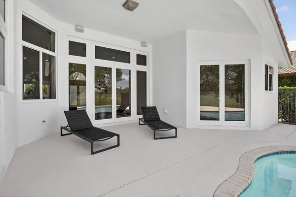 a swimming pool with outdoor seating and yard