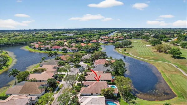 an aerial view of residential houses with outdoor space and lake view