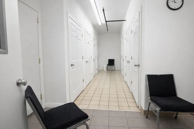 a view of a hallway with seating area