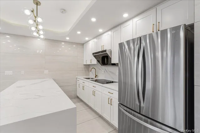 a kitchen with stainless steel appliances a refrigerator sink and microwave
