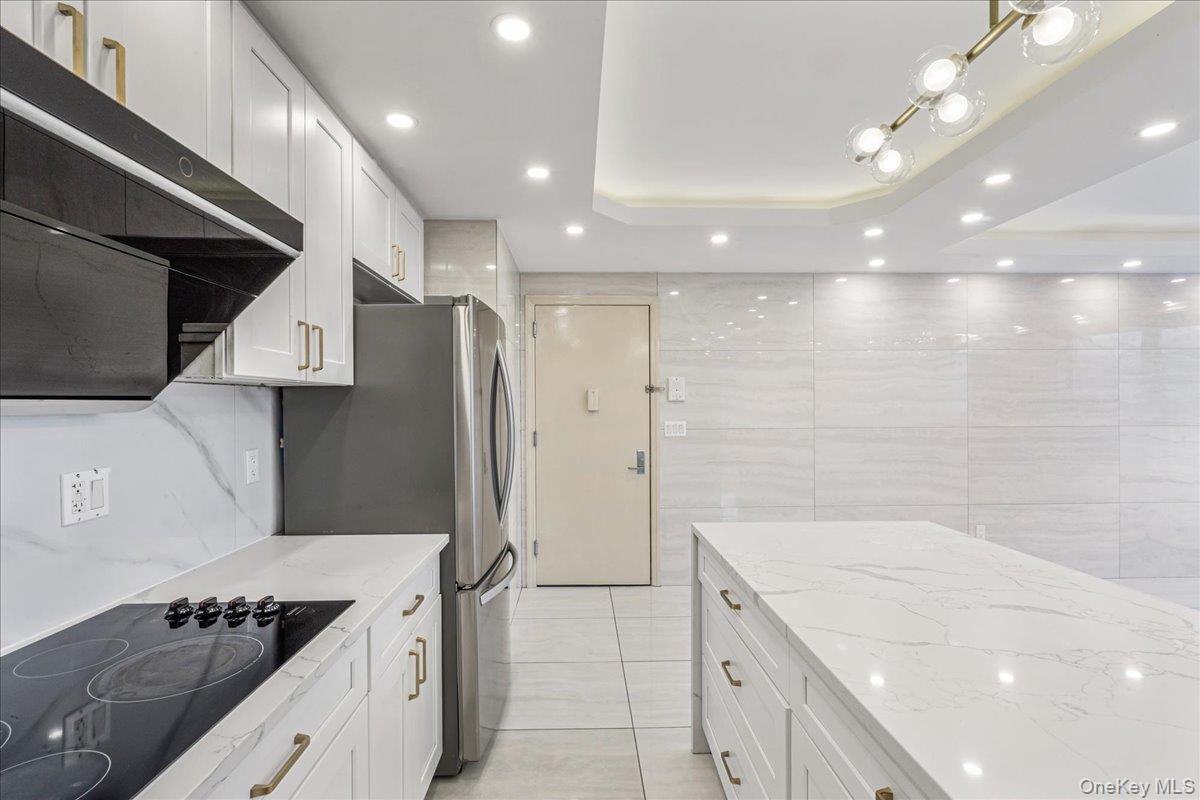 134-05 Dahlia Avenue, Unit 53A Queens, NY 11355 - Photo 5 of 13 a kitchen with a sink stove and refrigerator