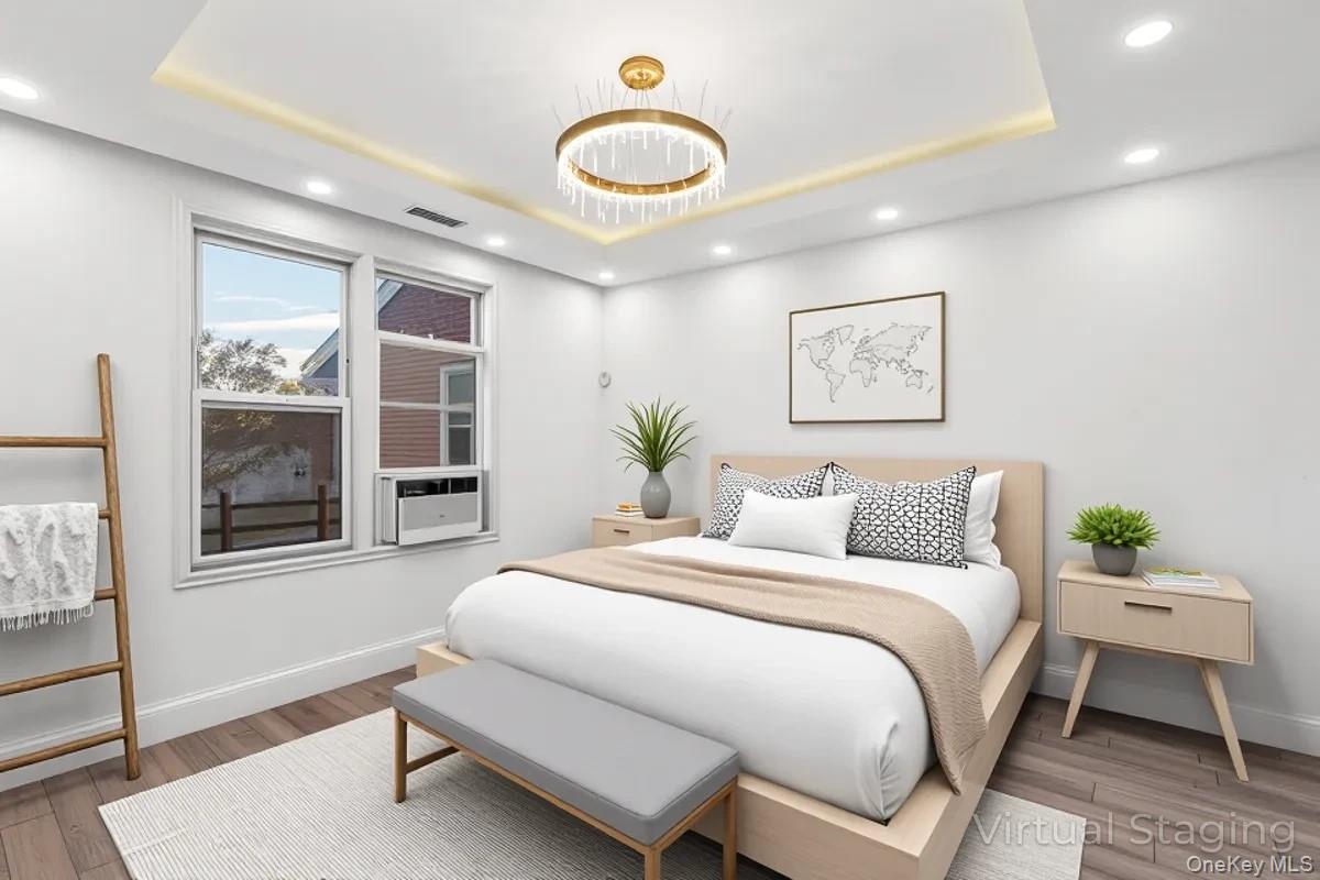 134-05 Dahlia Avenue, Unit 53A Queens, NY 11355 - Photo 6 of 13 a bedroom with a large bed and a window