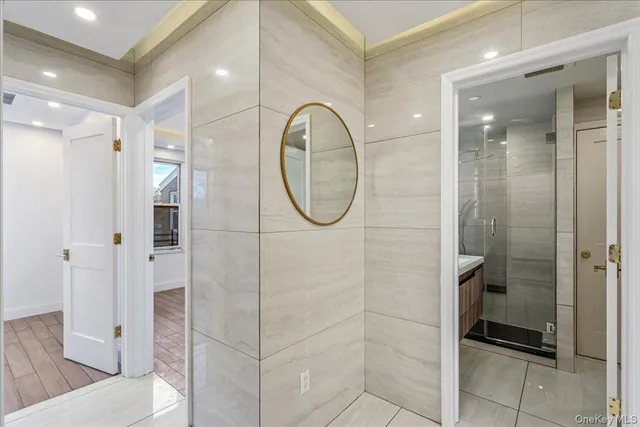 a bathroom with a glass shower door and a sink
