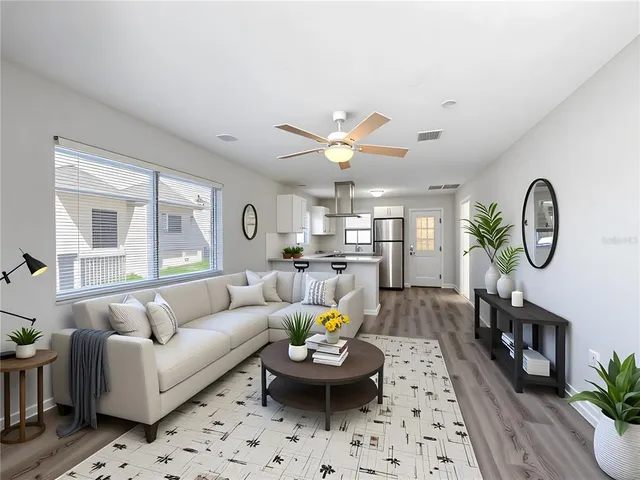a living room with furniture a window and a chandelier