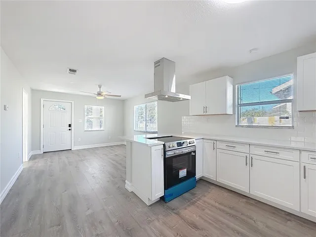 a kitchen with granite countertop a stove and a sink