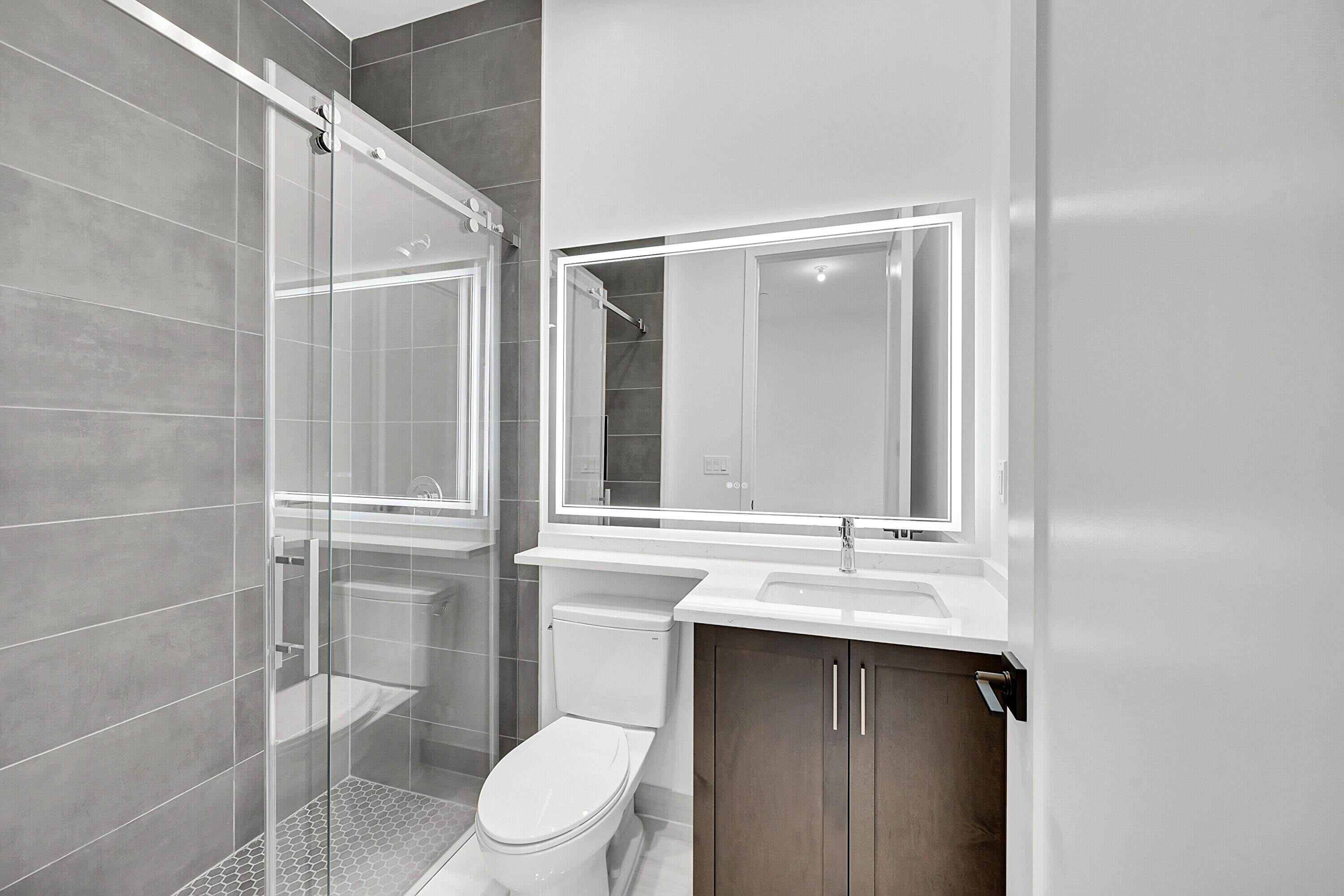 9979 Migration Point Palm Beach Gardens, FL 33412 - Photo 31 of 81 a bathroom with a sink vanity mirror and toilet