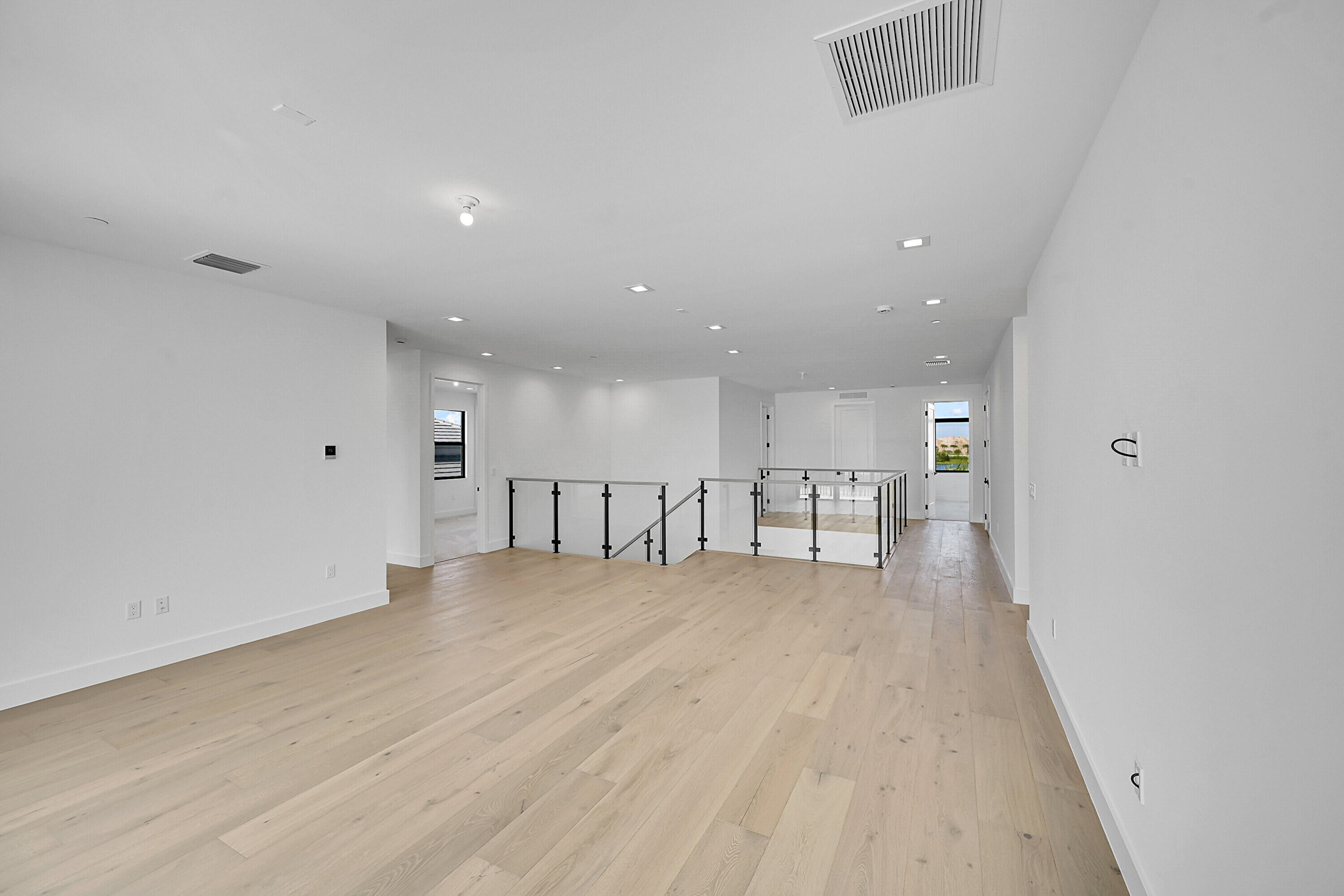 9979 Migration Point Palm Beach Gardens, FL 33412 - Photo 33 of 81 a view of an empty room with wooden floor