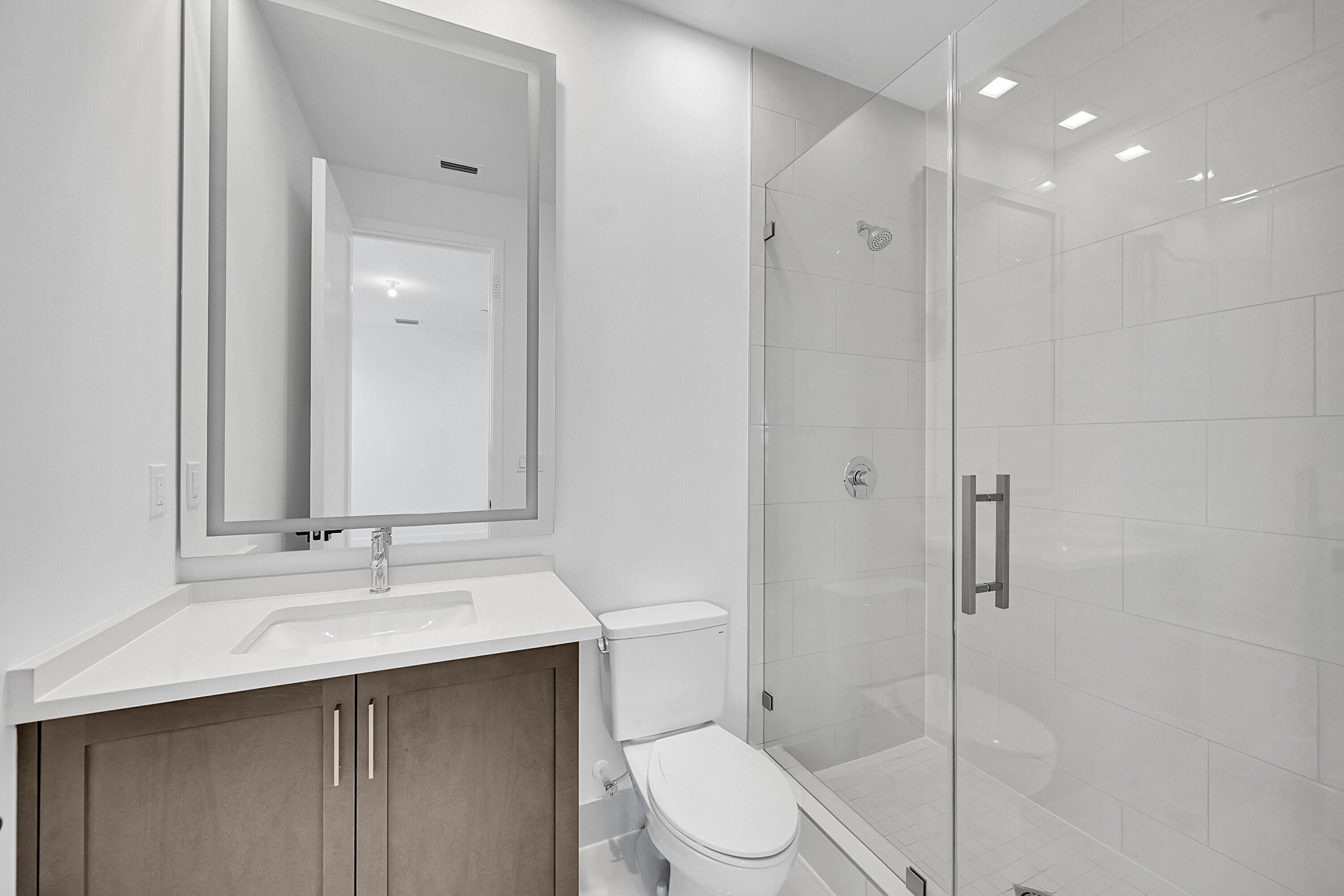 9979 Migration Point Palm Beach Gardens, FL 33412 - Photo 48 of 81 a bathroom with a sink a toilet and shower