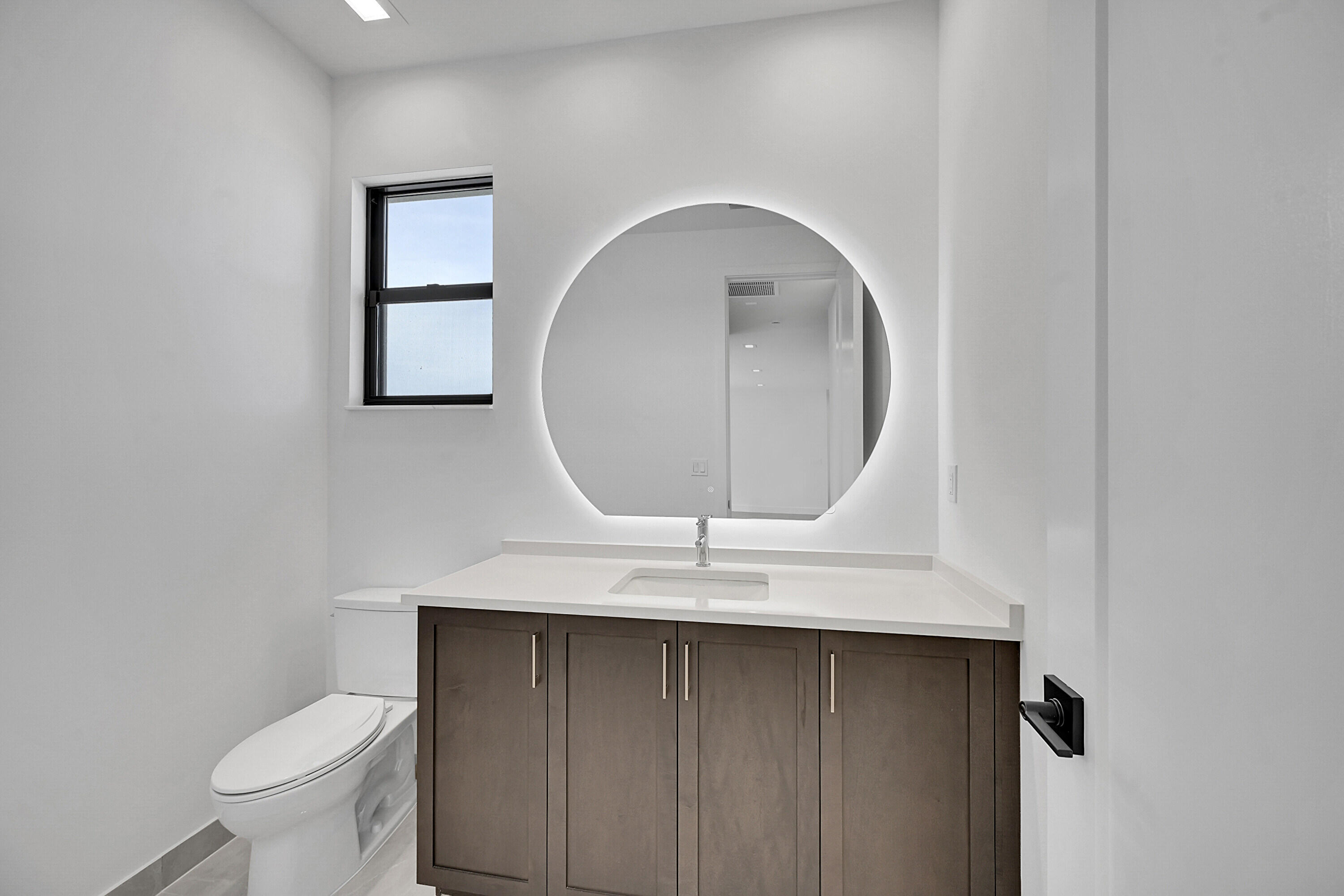 9979 Migration Point Palm Beach Gardens, FL 33412 - Photo 49 of 81 a bathroom with a sink a toilet and a mirror