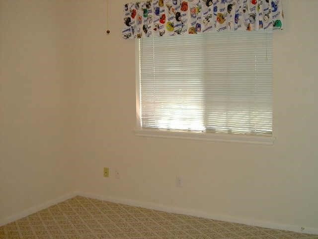 4542 Springfield Lakes Street Sugar Land, TX 77479 - Photo 13 of 16 Comfortable secondary bedroom with neutral colors and abundant natural light.