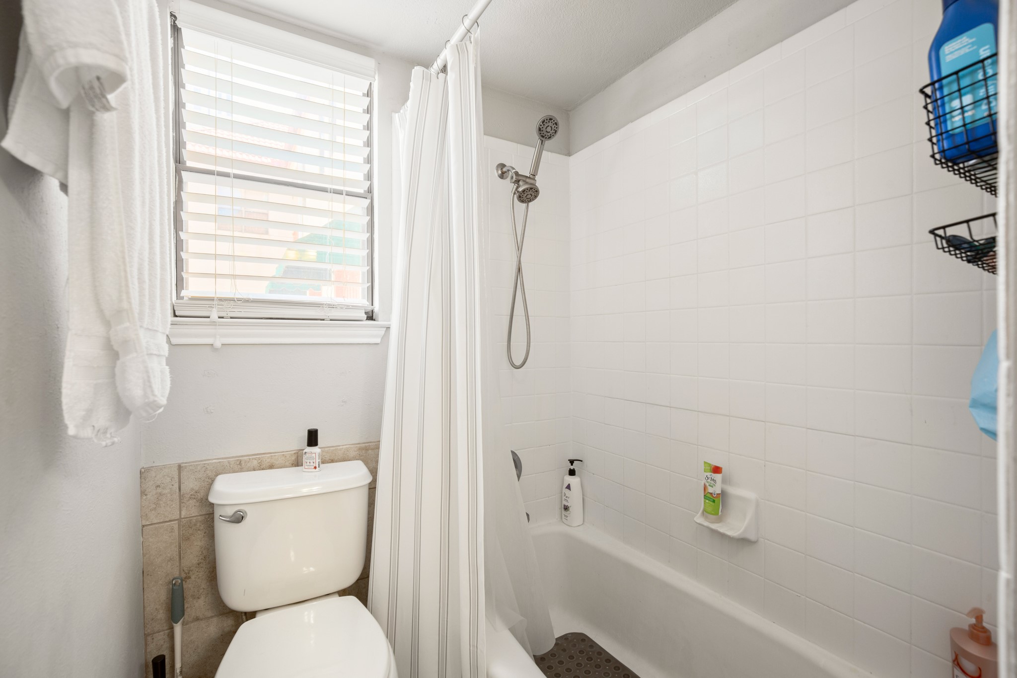 706 West 22nd Street, Unit 206 Austin, TX 78705 - Photo 11 of 18 Bathroom with shower / bath combination with curtain and toilet