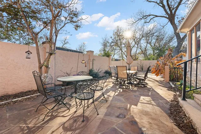 a view of a patio with a table and chairs