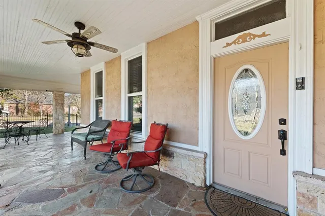 a living room with furniture a clock and a window