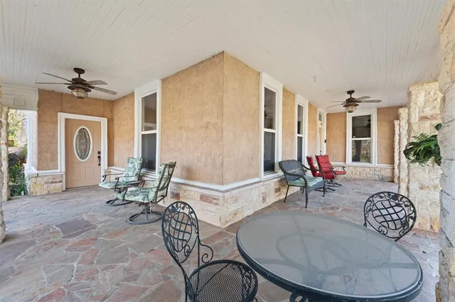 a living room with furniture a dining table and a chandelier