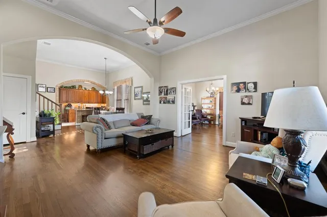 a living room with furniture and a chandelier