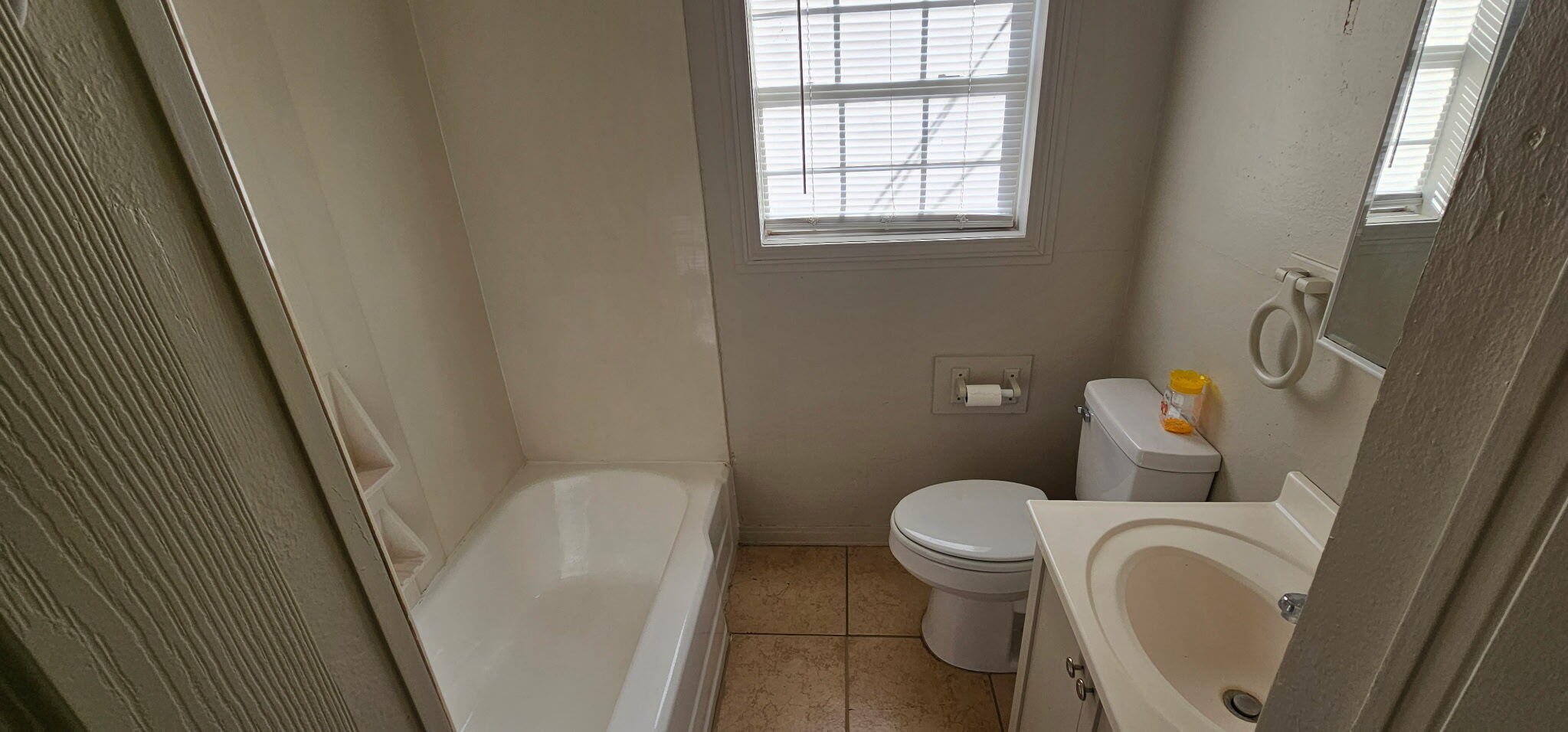 4319 33rd Street Lubbock, TX 79410 - Photo 4 of 6 a white toilet sitting next to a bathroom sink and a tub