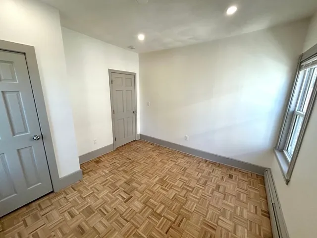 an empty room with wooden floor
