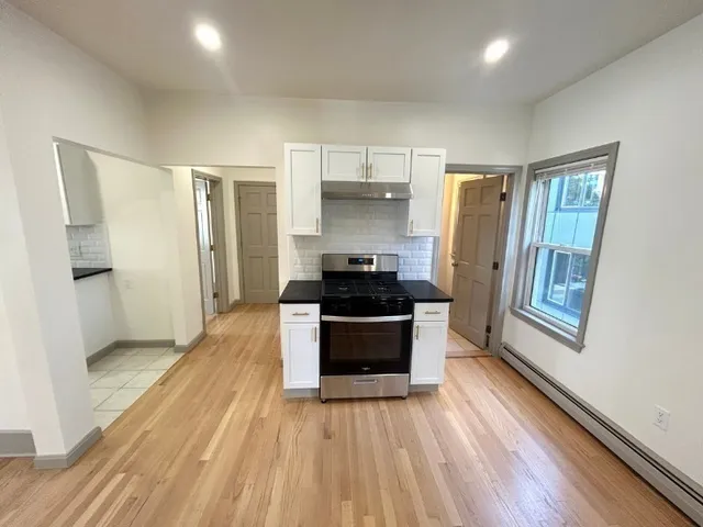 a kitchen with a refrigerator and a stove top oven