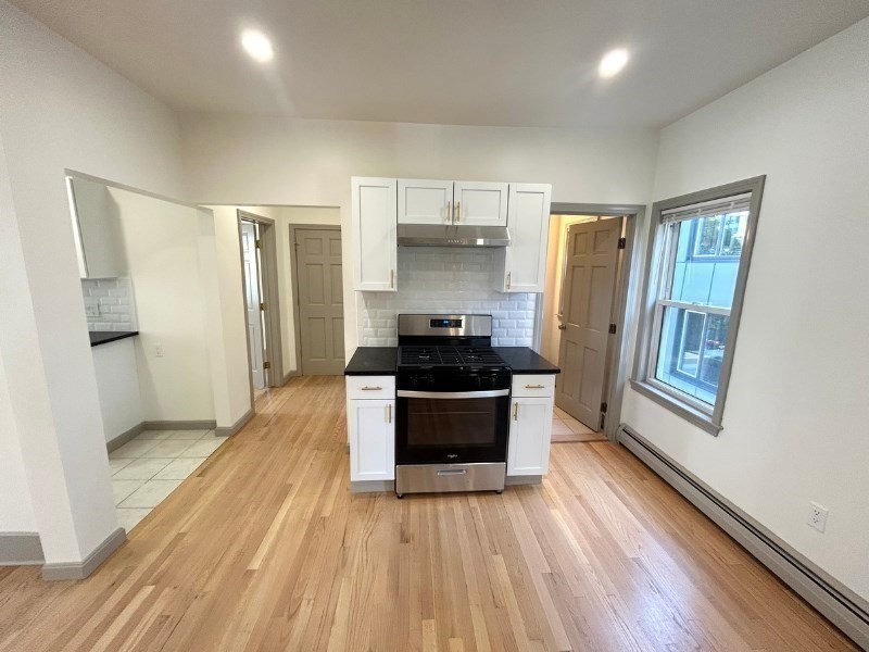 116 Prospect Street, Unit 1 Somerville, MA 02143 - Photo 2 of 21 a kitchen with a refrigerator and a stove top oven
