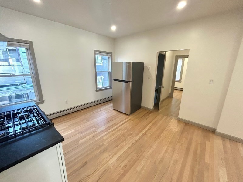 116 Prospect Street, Unit 1 Somerville, MA 02143 - Photo 4 of 21 a view of kitchen with refrigerator and window
