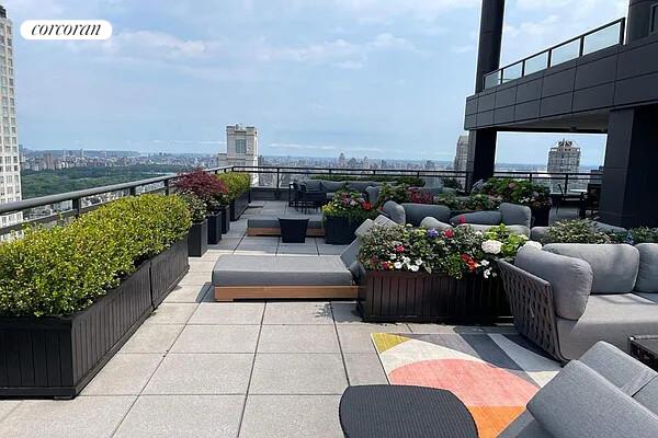 117 East 57th Street, Unit 32G Manhattan, NY 10022 - Photo 12 of 13 a view of a balcony with chairs potted plants