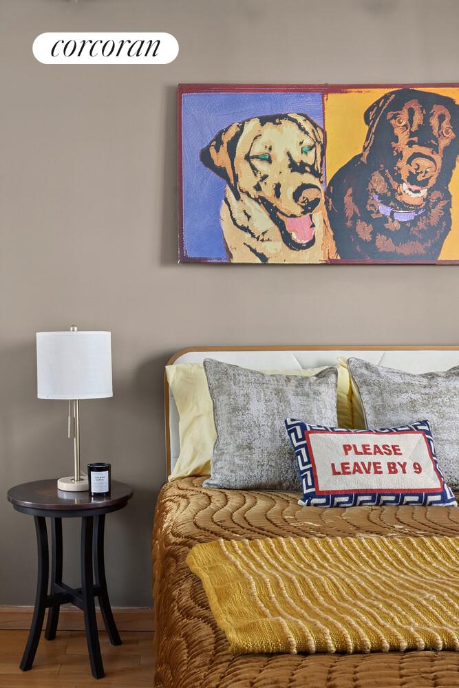 117 East 57th Street, Unit 32G Manhattan, NY 10022 - Photo 8 of 13 a bedroom with a bed and painting on the wall