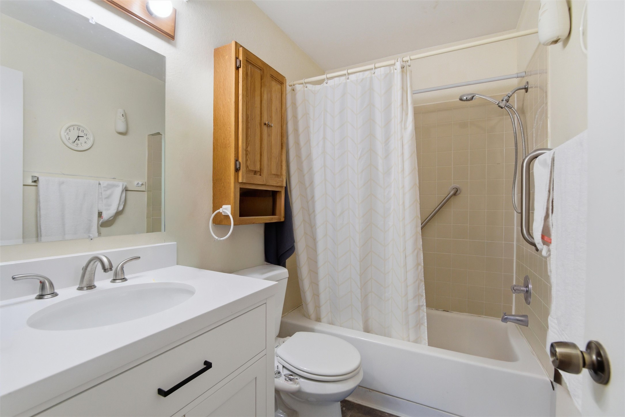 2000 Magazine Street Austin, TX 78727 - Photo 15 of 30 A well-appointed bathroom features a crisp white vanity and a practical shower-over-tub setup.
