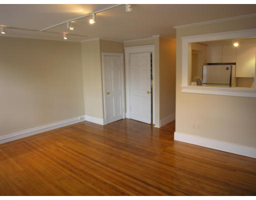 a view of a room with wooden floor and a window