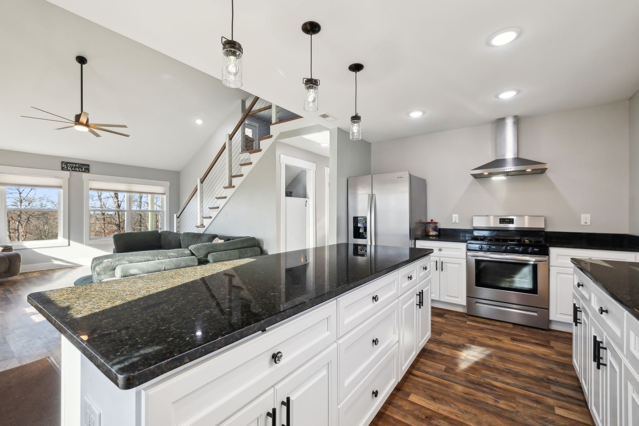 93 Halliburton Road Vanleer, TN 37181 - Photo 12 of 75 a kitchen with stainless steel appliances granite countertop a sink a stove and a wooden floors