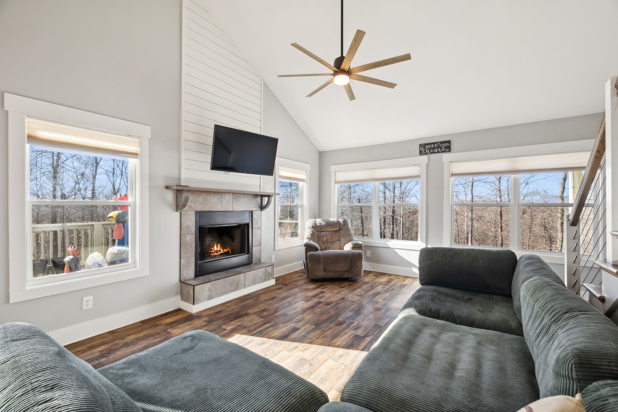 93 Halliburton Road Vanleer, TN 37181 - Photo 13 of 75 a living room with furniture a flat screen tv and a fireplace