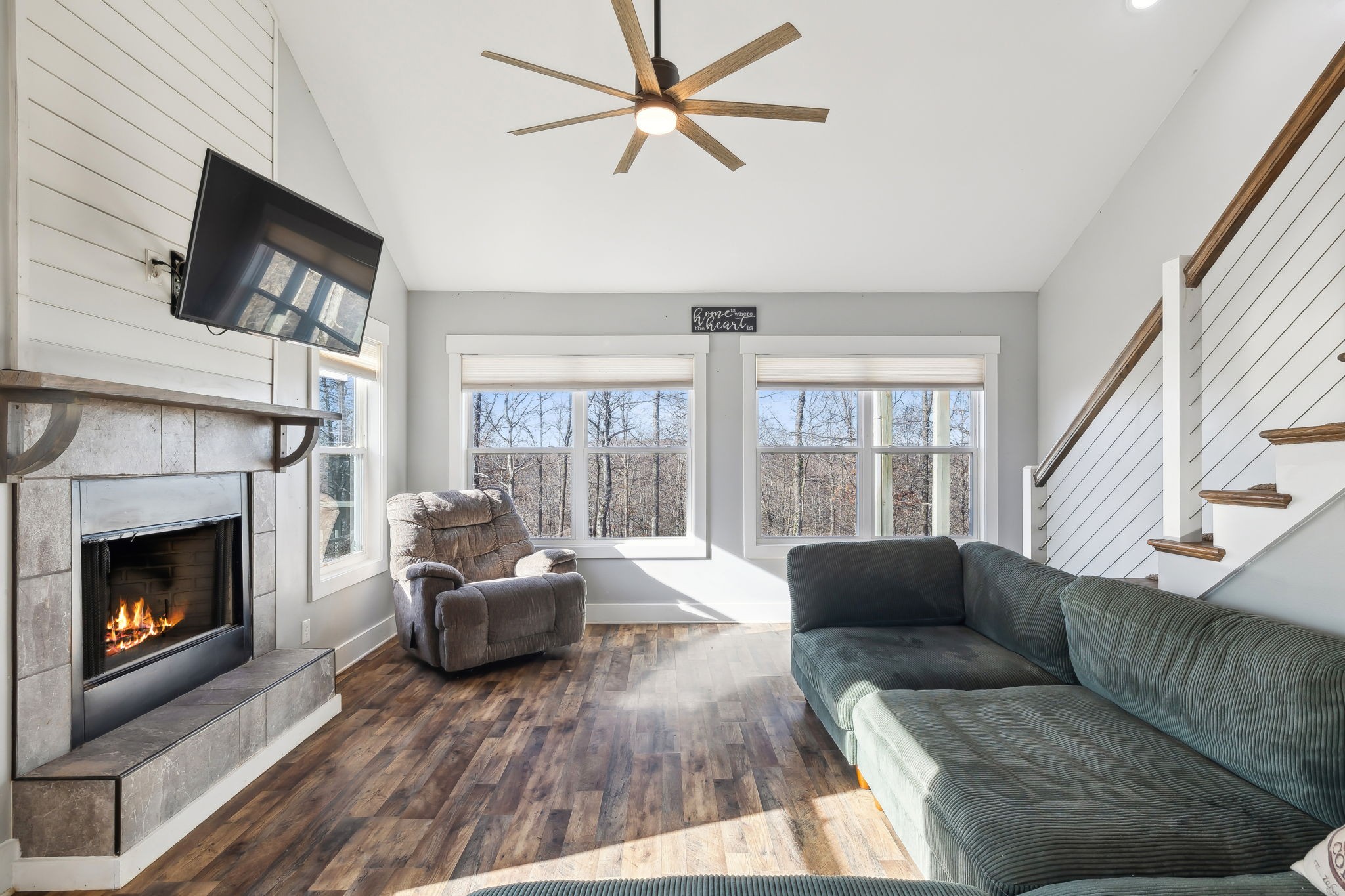 93 Halliburton Road Vanleer, TN 37181 - Photo 15 of 75 a living room with furniture a flat screen tv and a fireplace