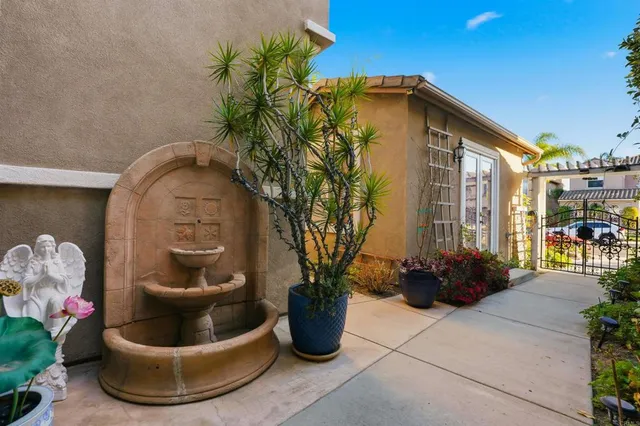 a view of a house that has a flower garden
