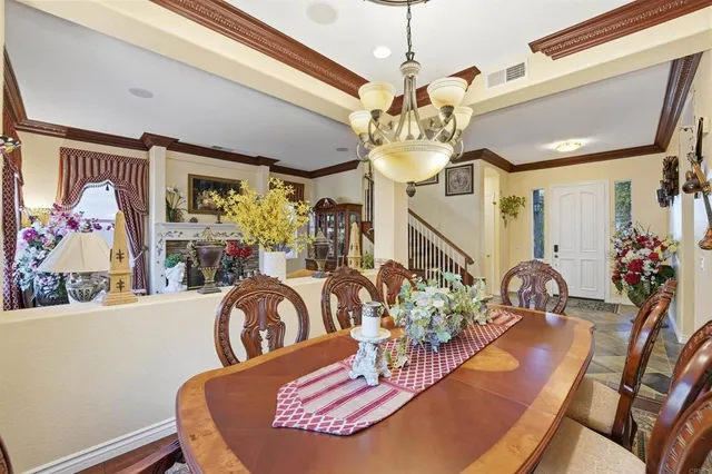 a view of a dining room with furniture and chandelier