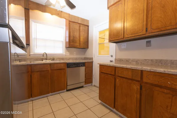 a kitchen with granite countertop cabinets sink and window