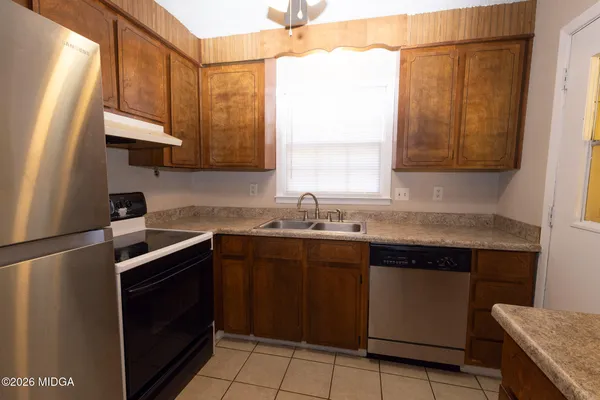 a kitchen with a sink stove and cabinets