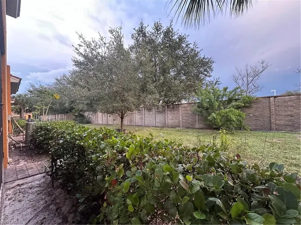 a large white kitchen with a sink and a stove top oven
