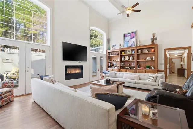 a living room with furniture and a floor to ceiling window