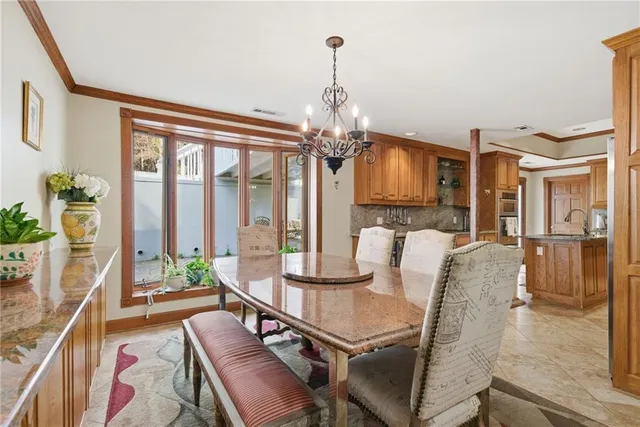 a large kitchen with stainless steel appliances granite countertop a stove a sink dishwasher and a refrigerator