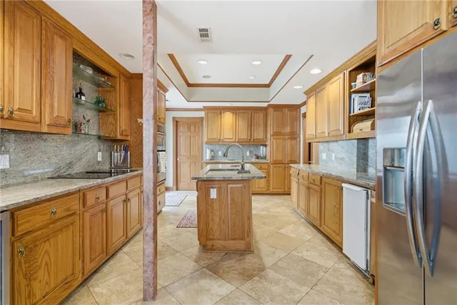 a kitchen with a refrigerator and a sink