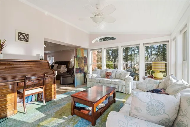 a view of a chairs and table in the back yard of the house