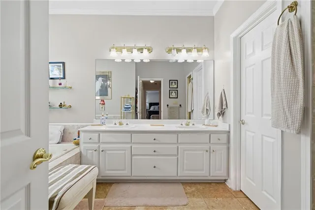 a bathroom with a sink a chandelier and a bathtub