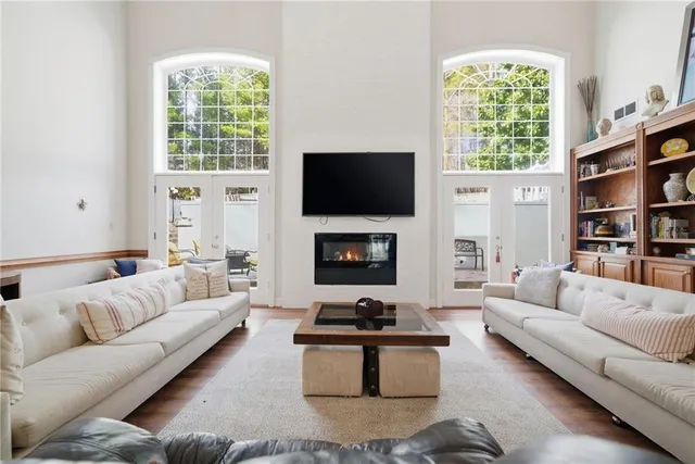 a living room with furniture a flat screen tv and a fireplace