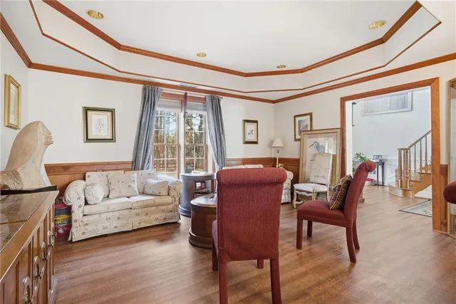 a view of a dining room with furniture wooden floor and chandelier
