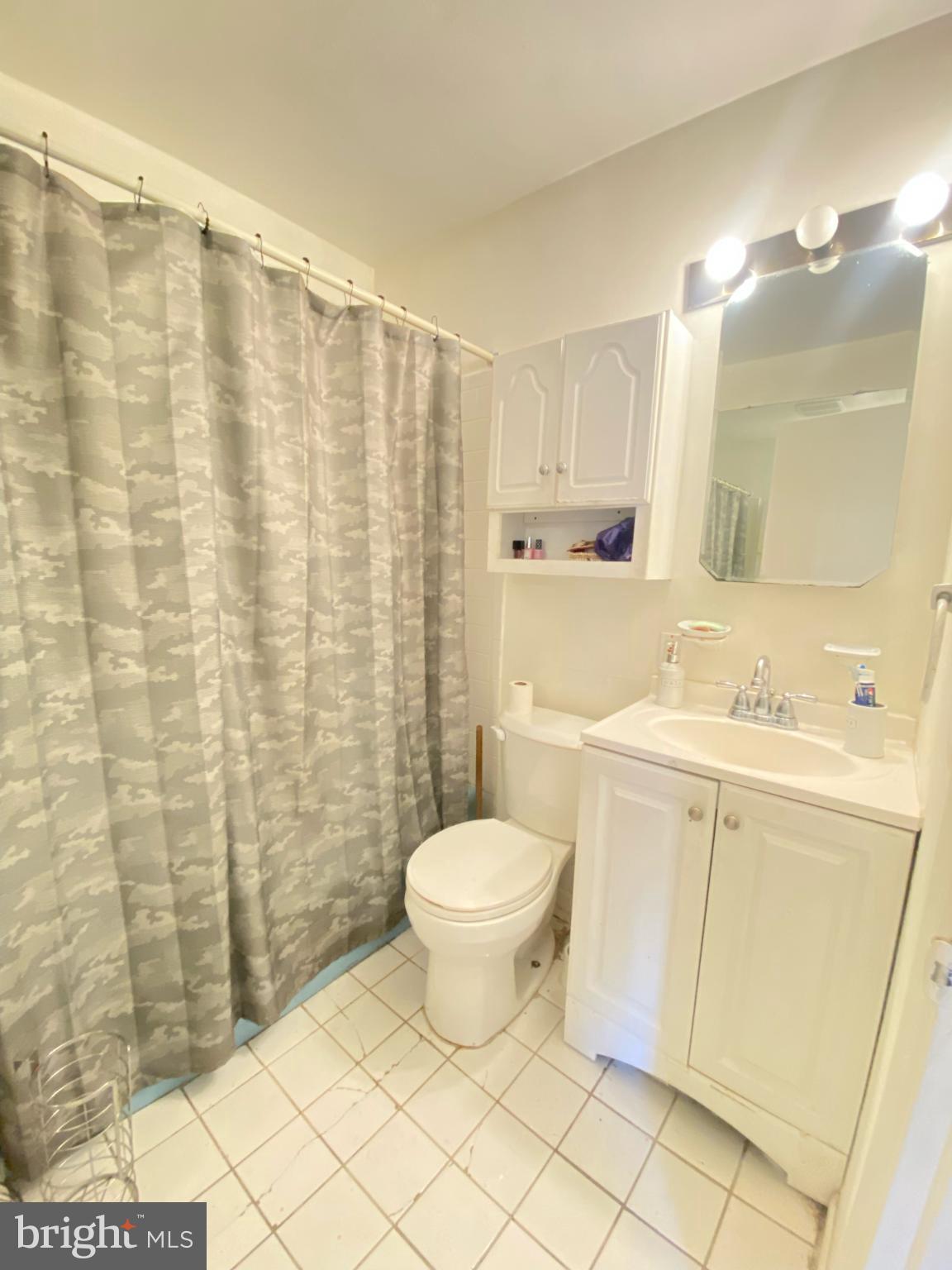 9601 East Light Drive Silver Spring, MD 20903 - Photo 11 of 25 a bathroom with a sink toilet and shower
