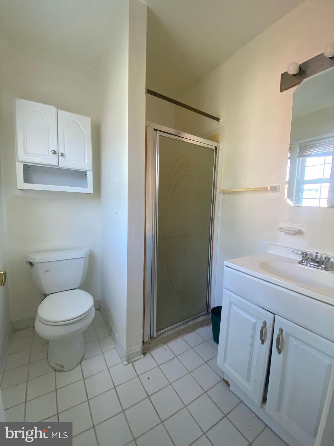 9601 East Light Drive Silver Spring, MD 20903 - Photo 14 of 25 a bathroom with a toilet a sink and a mirror