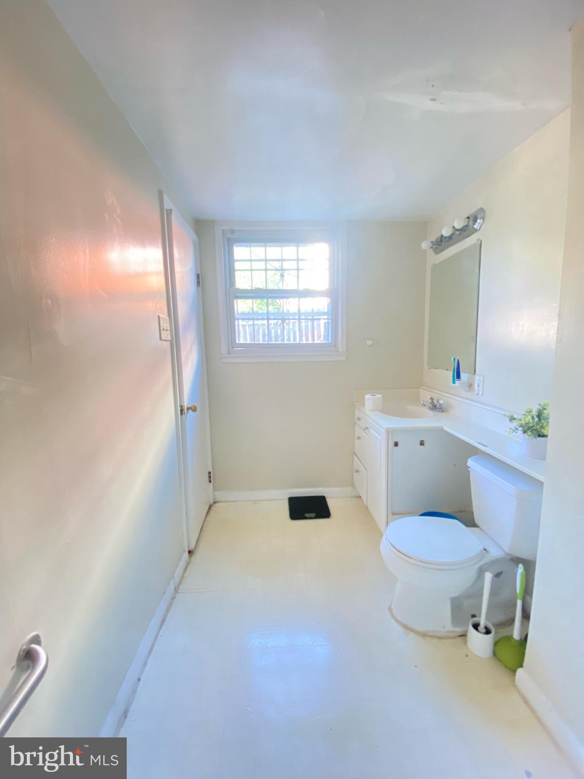 9601 East Light Drive Silver Spring, MD 20903 - Photo 18 of 25 a bathroom with a toilet sink and a mirror